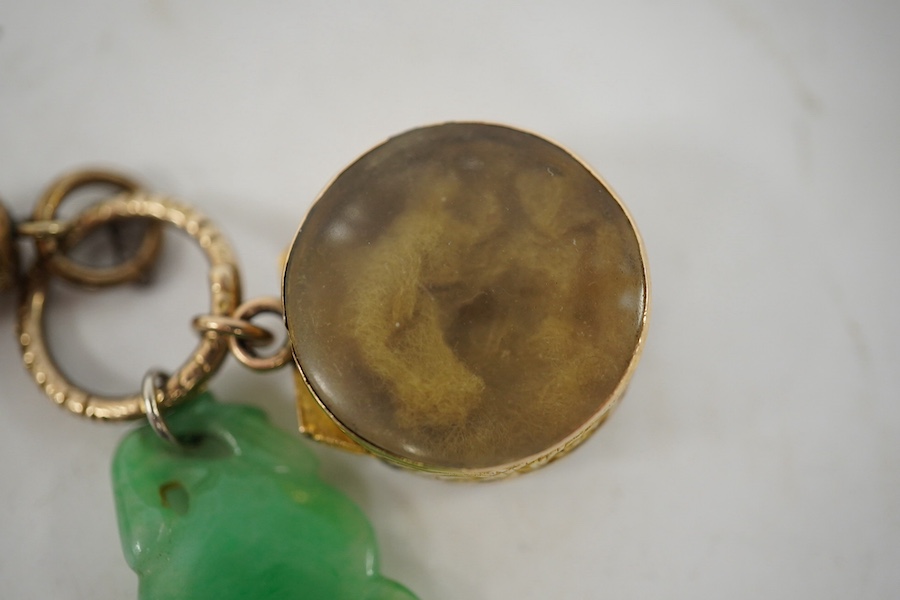 An unmarked yellow metal vinaigrette, 18mm, together with a yellow metal overlaid combination propelling pencil/penknife and a carved jade fob. Condition - fair to good.